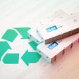 Li-Ion electric vehicle battery recycling concept. Recycle symbol with EV batteries on wooden desk. 3d rendering.