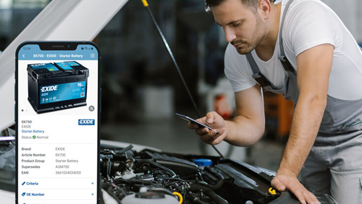 © Shutterstock Mechanic with phone looking at car engine