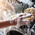 People cleaning car with sponge at car wash
